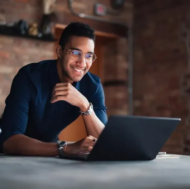 Smiling professional working on a laptop